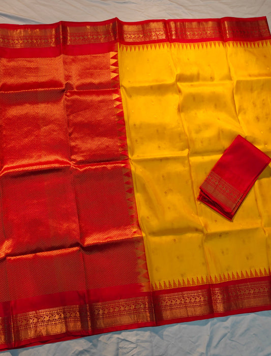 Yellow and red saree with a border on a light blue fabric background