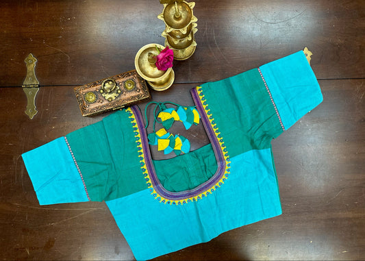 Traditional turquoise blouse with colorful embroidery